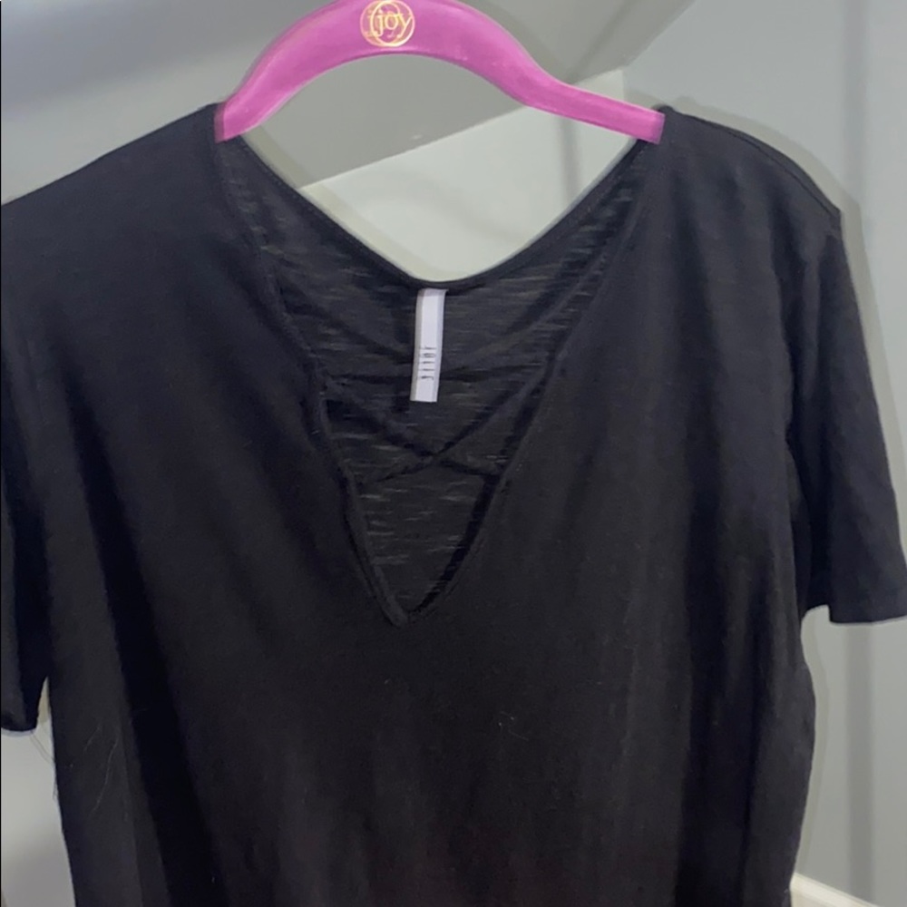 a black shirt with crisscross detailing on the top